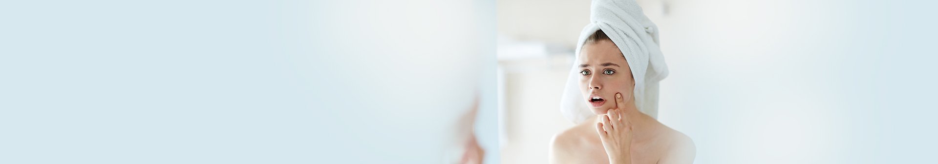 ragazza che controlla brufoli sottopelle allo specchio